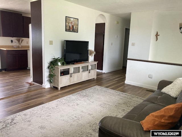 living room with dark hardwood / wood-style flooring