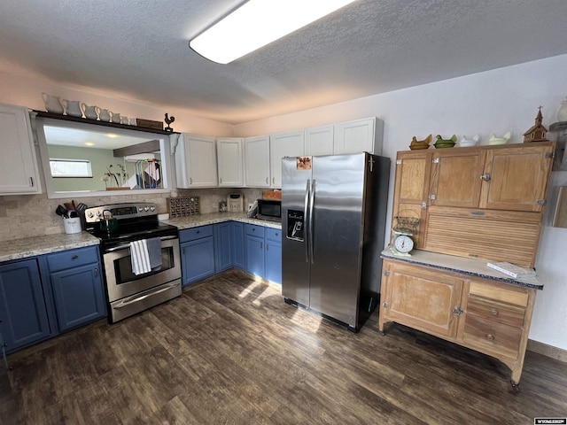 kitchen with blue cabinets, backsplash, dark hardwood / wood-style flooring, stainless steel appliances, and a textured ceiling