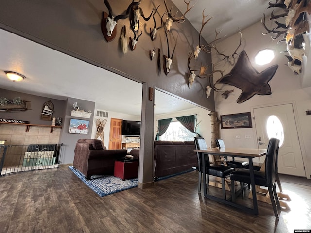 dining area with lofted ceiling and dark hardwood / wood-style floors