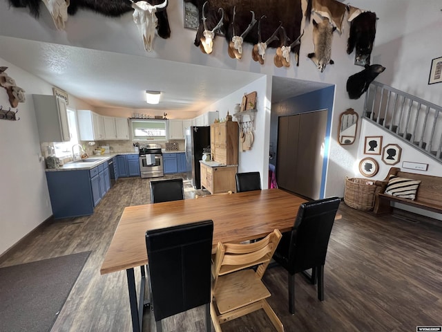 dining room with sink and dark wood-type flooring