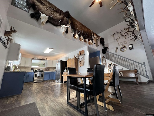 dining space featuring dark hardwood / wood-style flooring, sink, and ceiling fan