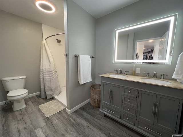 bathroom with hardwood / wood-style flooring, vanity, toilet, and a shower with curtain