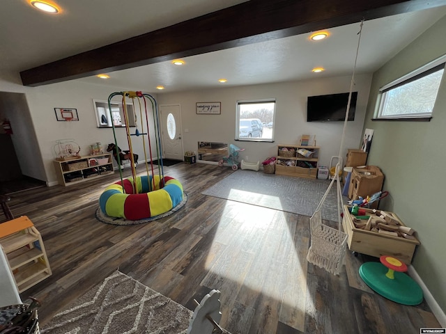 game room with dark hardwood / wood-style flooring and beam ceiling