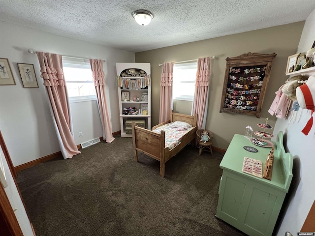 carpeted bedroom with multiple windows and a textured ceiling