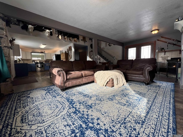 living room with a fireplace and a textured ceiling