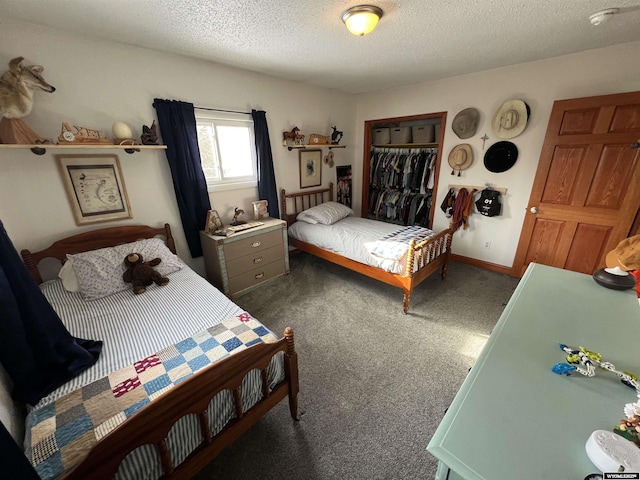 carpeted bedroom with a textured ceiling and a closet