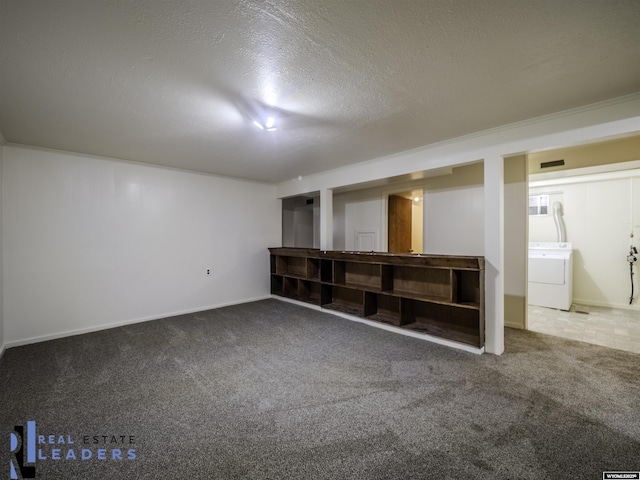 basement featuring washer / dryer, carpet, and a textured ceiling