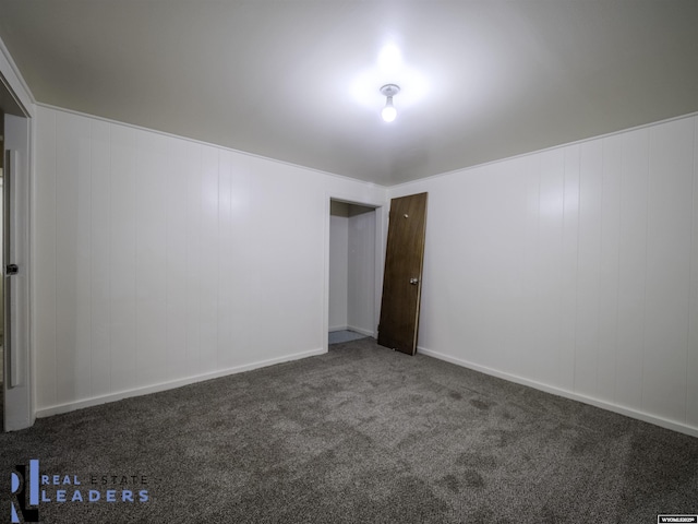 empty room with dark carpet