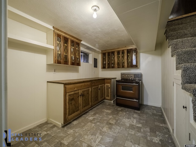 kitchen with range with electric cooktop and a textured ceiling