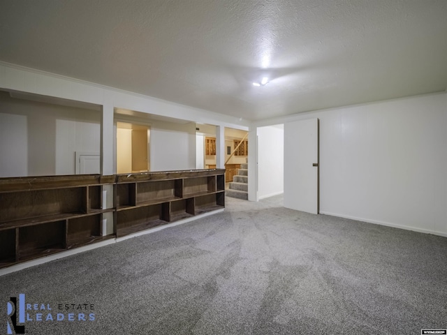 basement featuring a textured ceiling and carpet