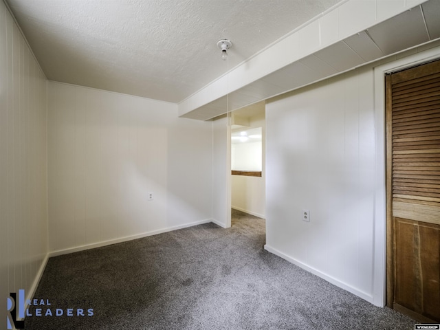 carpeted spare room featuring wooden walls