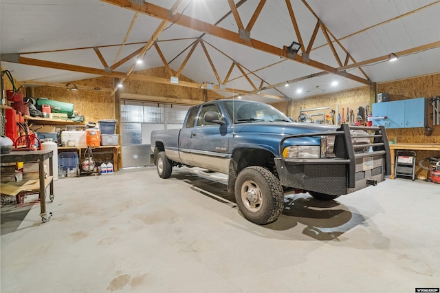 garage with wood walls and a workshop area