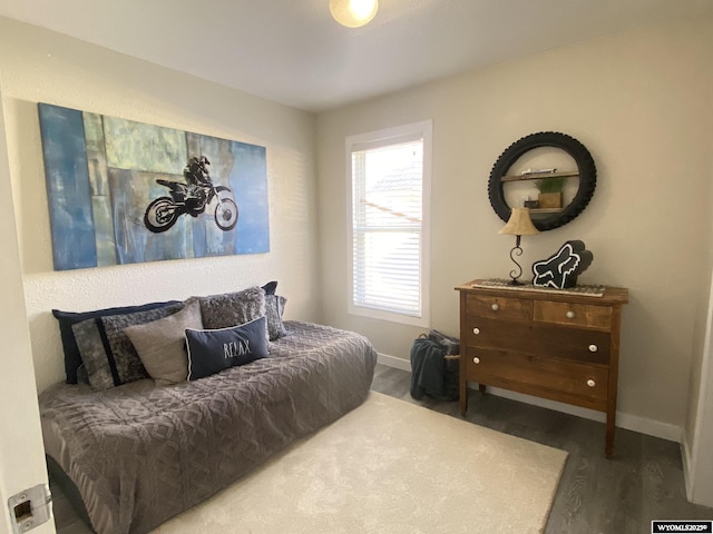 bedroom featuring baseboards and wood finished floors