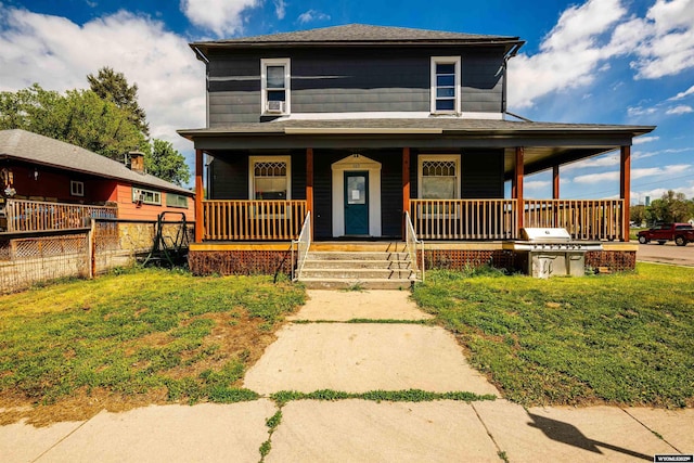 view of front facade featuring a front yard and covered porch