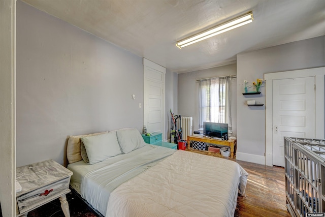 bedroom with dark wood-type flooring