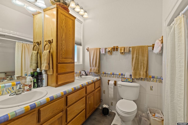 bathroom featuring double vanity, toilet, tile patterned floors, and a sink