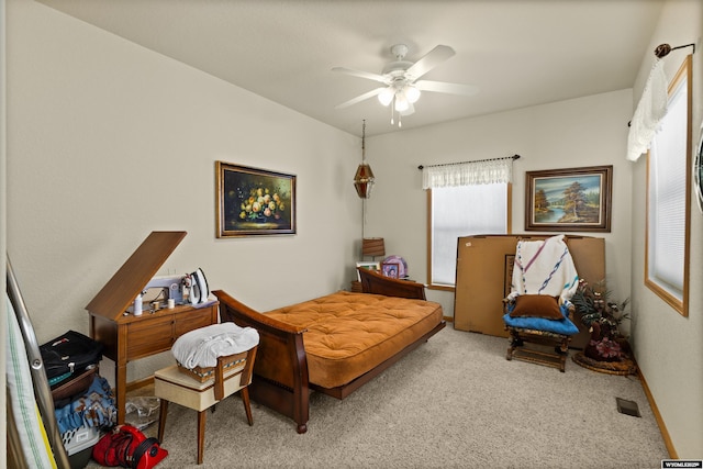 carpeted bedroom with visible vents and a ceiling fan