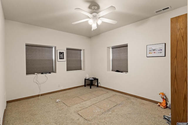 spare room featuring visible vents, baseboards, and a ceiling fan