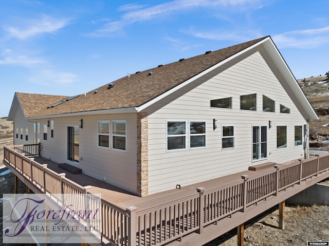 back of house featuring a wooden deck and a shingled roof