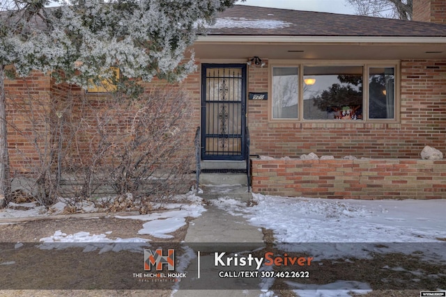 view of snow covered property entrance