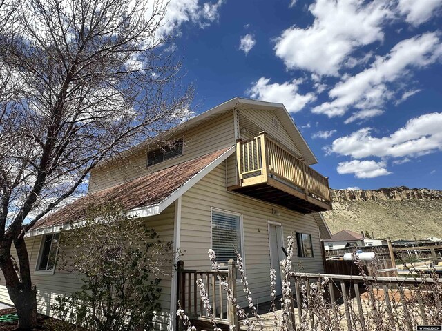 205 Oakley St, Kemmerer, WY 83101 - view of side of property with a balcony, fence, and a mountain view