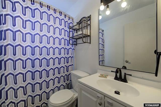 bathroom with vanity, toilet, and curtained shower