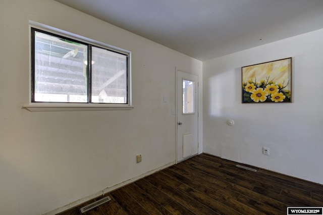 empty room with dark hardwood / wood-style floors