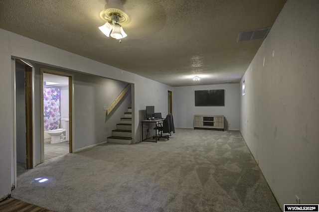 basement with carpet floors and a textured ceiling