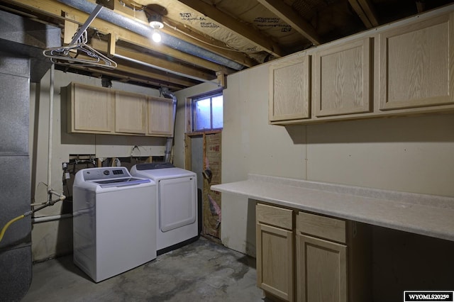 laundry room featuring washing machine and dryer and cabinets