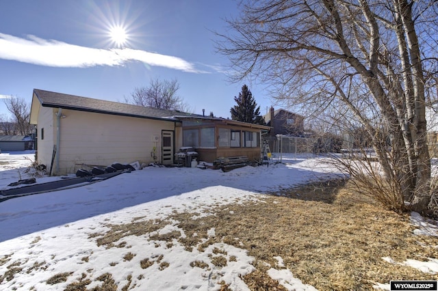 view of snow covered rear of property