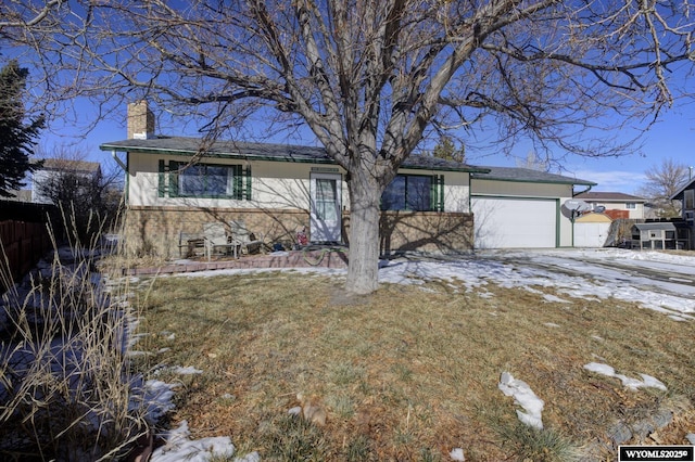 ranch-style house with a garage and a front yard