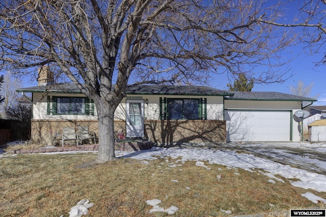 ranch-style home with a garage and a front lawn