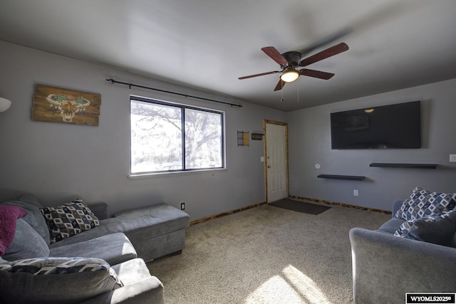 carpeted living room with ceiling fan