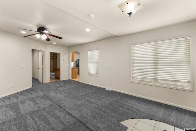 carpeted spare room with ceiling fan