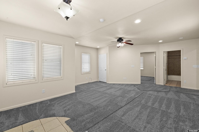 unfurnished living room with ceiling fan and carpet floors