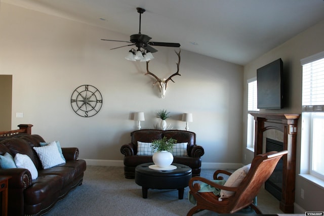 living room with lofted ceiling, a fireplace, carpet, and a wealth of natural light