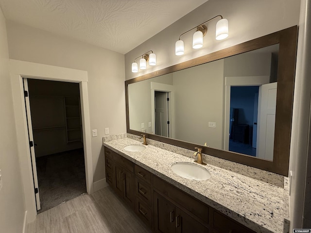 bathroom with vanity and a textured ceiling