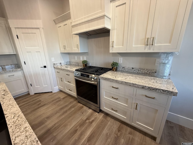 kitchen featuring white cabinetry, dark hardwood / wood-style flooring, and gas stove