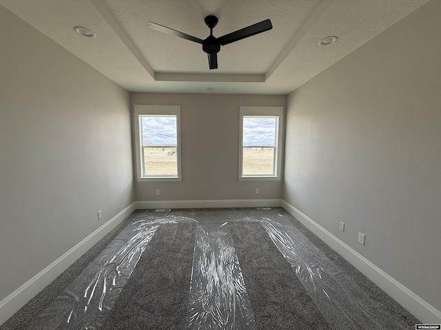 2707 Bailey Blvd, Rock Springs, WY 82901 - unfurnished room with a raised ceiling, baseboards, and a ceiling fan