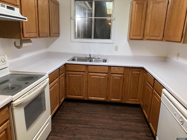 kitchen featuring white appliances, dark hardwood / wood-style flooring, and sink