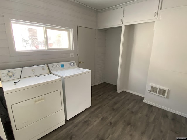 clothes washing area with dark hardwood / wood-style floors and washer and clothes dryer