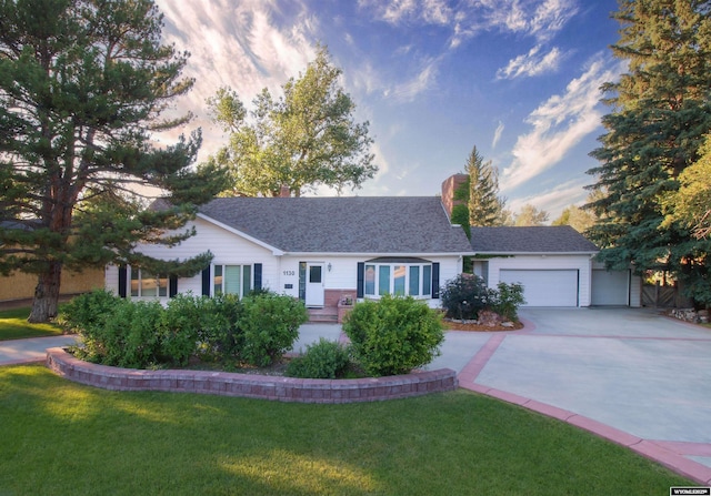 ranch-style home with a garage and a front yard