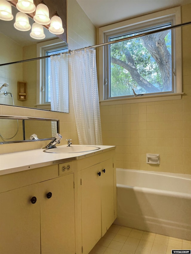 bathroom featuring tile patterned flooring, shower / tub combo, vanity, and a chandelier