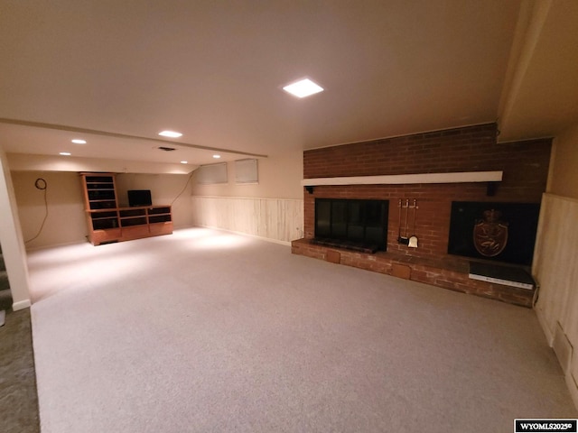 basement featuring carpet flooring and a brick fireplace