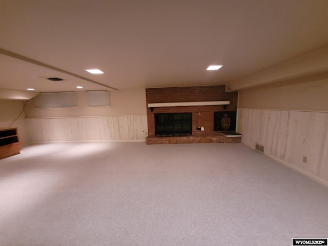 unfurnished living room featuring carpet flooring and a fireplace