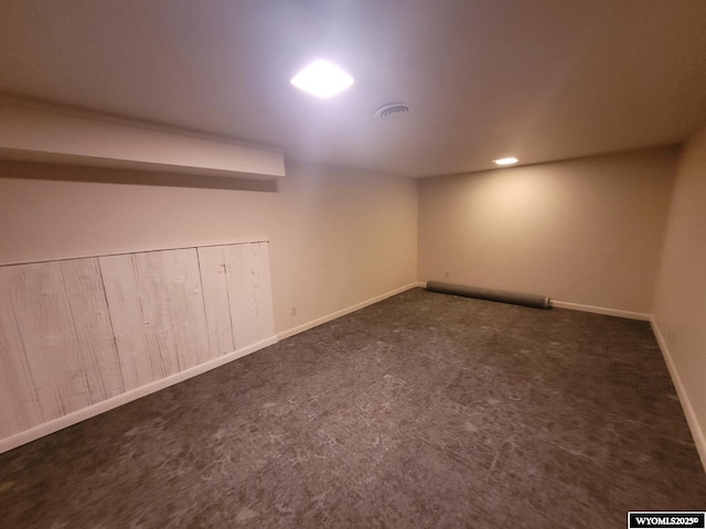 basement with dark colored carpet