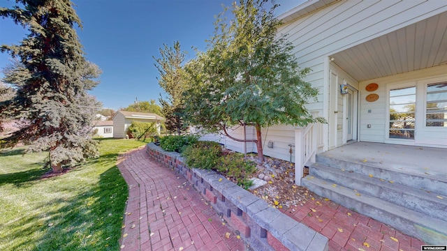 exterior space with a patio and a lawn