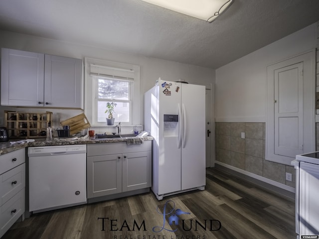 kitchen featuring white cabinetry, dark hardwood / wood-style flooring, sink, and white appliances