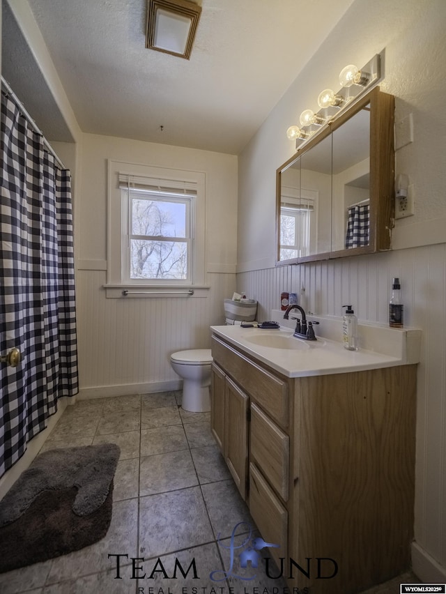 bathroom with vanity, toilet, and tile patterned flooring