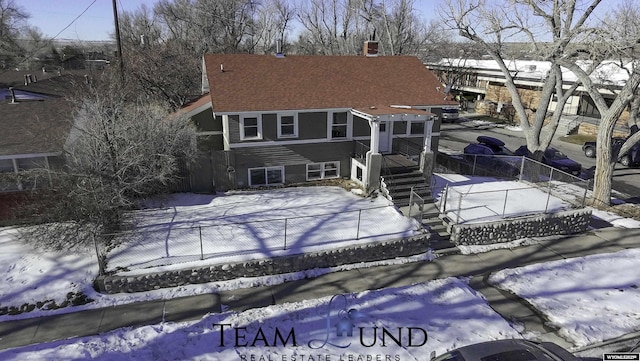 view of snow covered rear of property